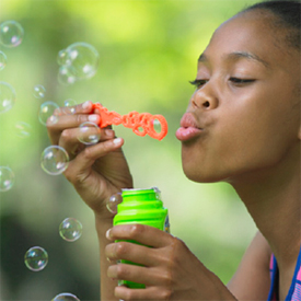 girl blowing bubbles